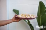 person holding purple ceramic plate with pasta 4078193 scaled