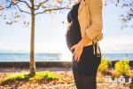 pregnant woman wearing beige long sleeve shirt standing near 132730 scaled