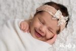 Why do newborn babies smile scaled